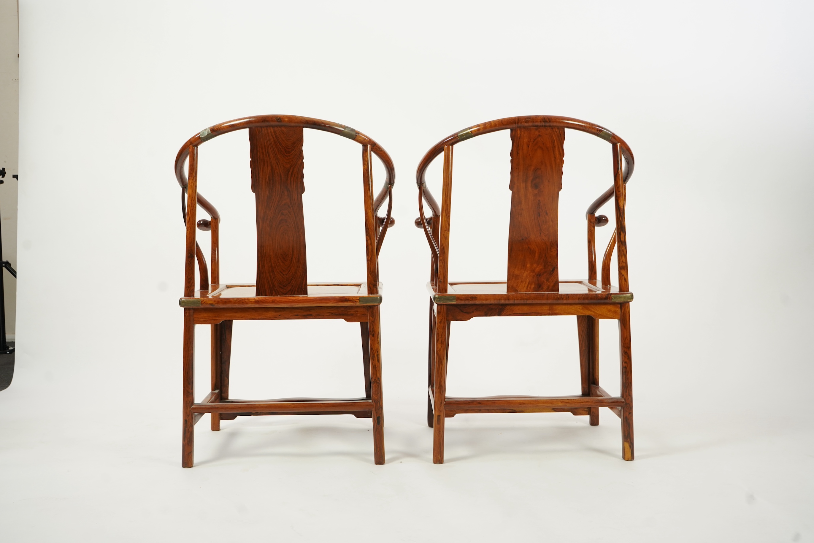 A pair of Chinese huanghuali and brass mounted horseshoe-back armchairs, quanyi, 19th century